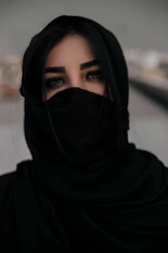 woman in black hijab taking selfie