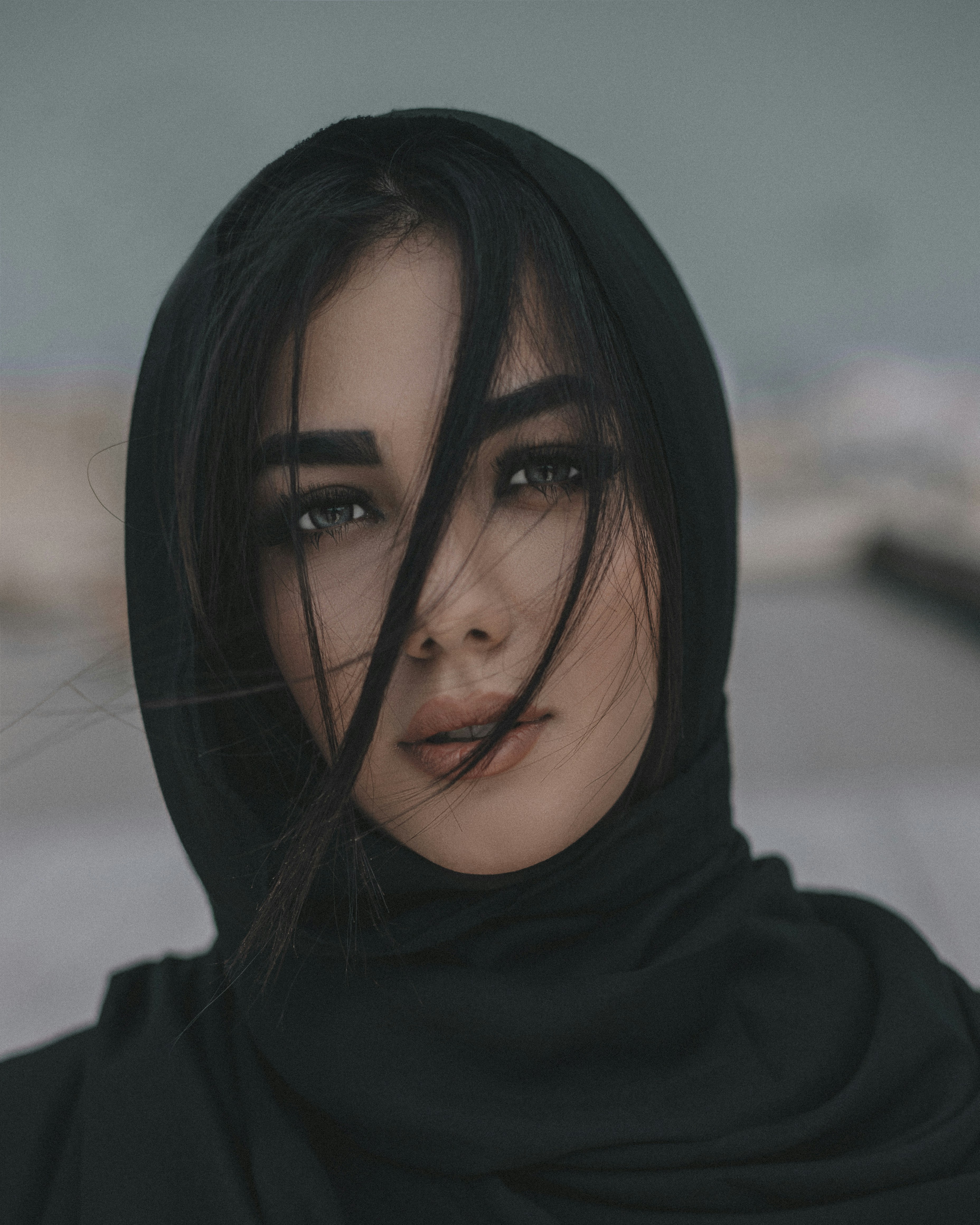 woman in black hijab taking selfie