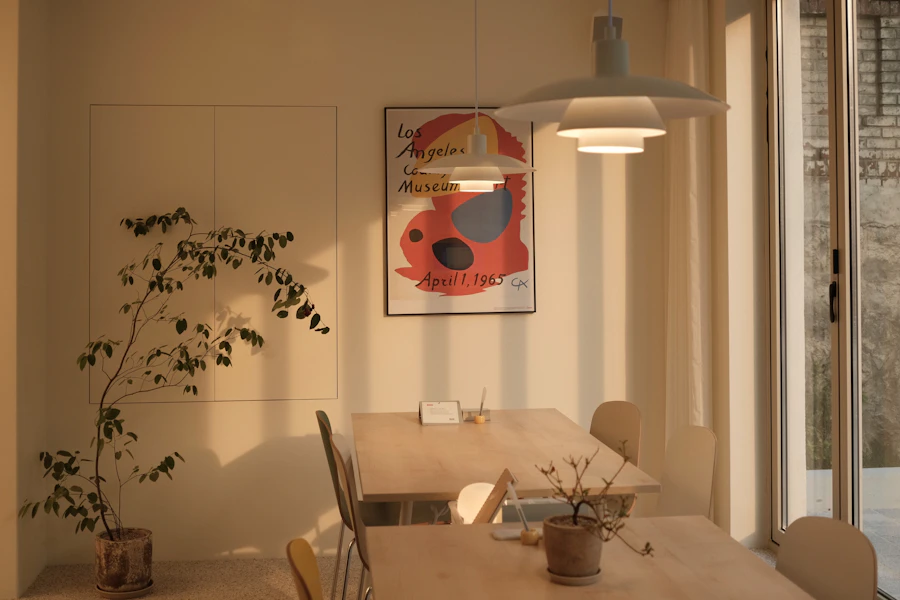 Brown wooden dining table with chairs in a sunlit room