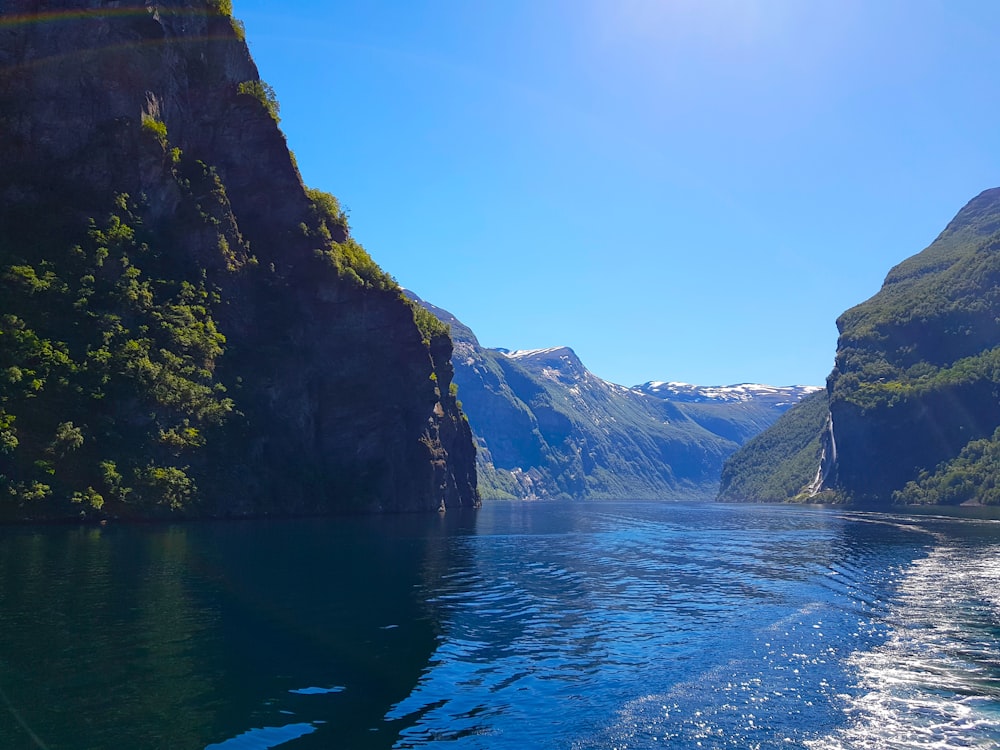 body of water between mountains during daytime