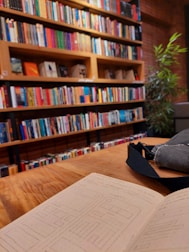 A cozy reading nook with nature books and handwritten lesson plans on cream-colored paper.