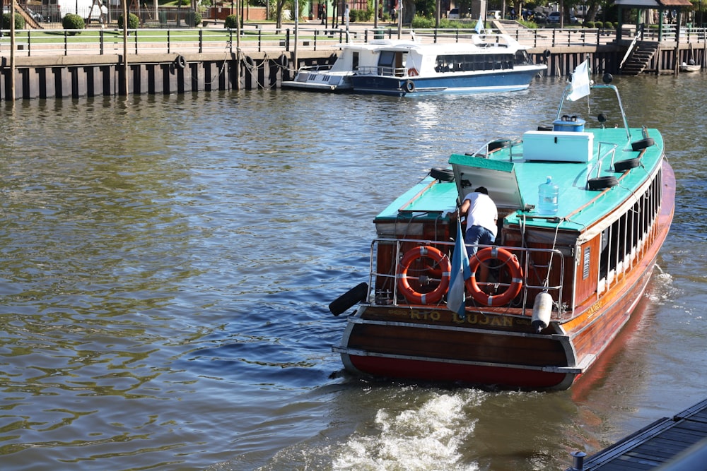 red and black boat on water during daytime