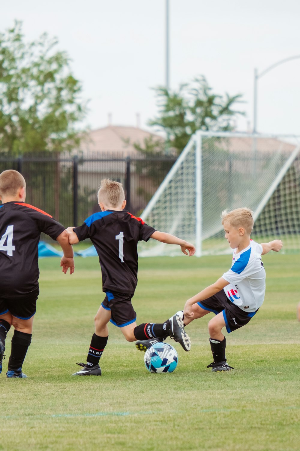 2 men playing soccer during daytime