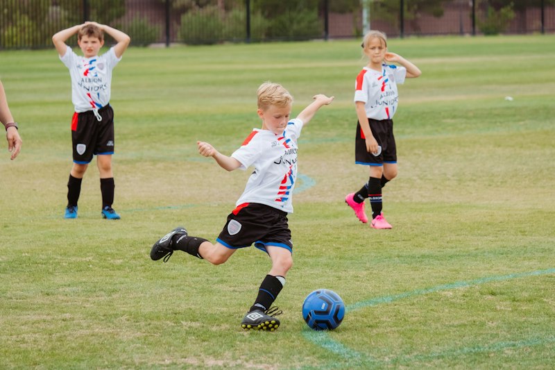 Players developing technique on grass