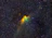 A close-up of a vibrant nebula glowing in deep space with stars scattered around.