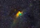 A close-up of a vibrant nebula glowing in deep space with stars scattered around.