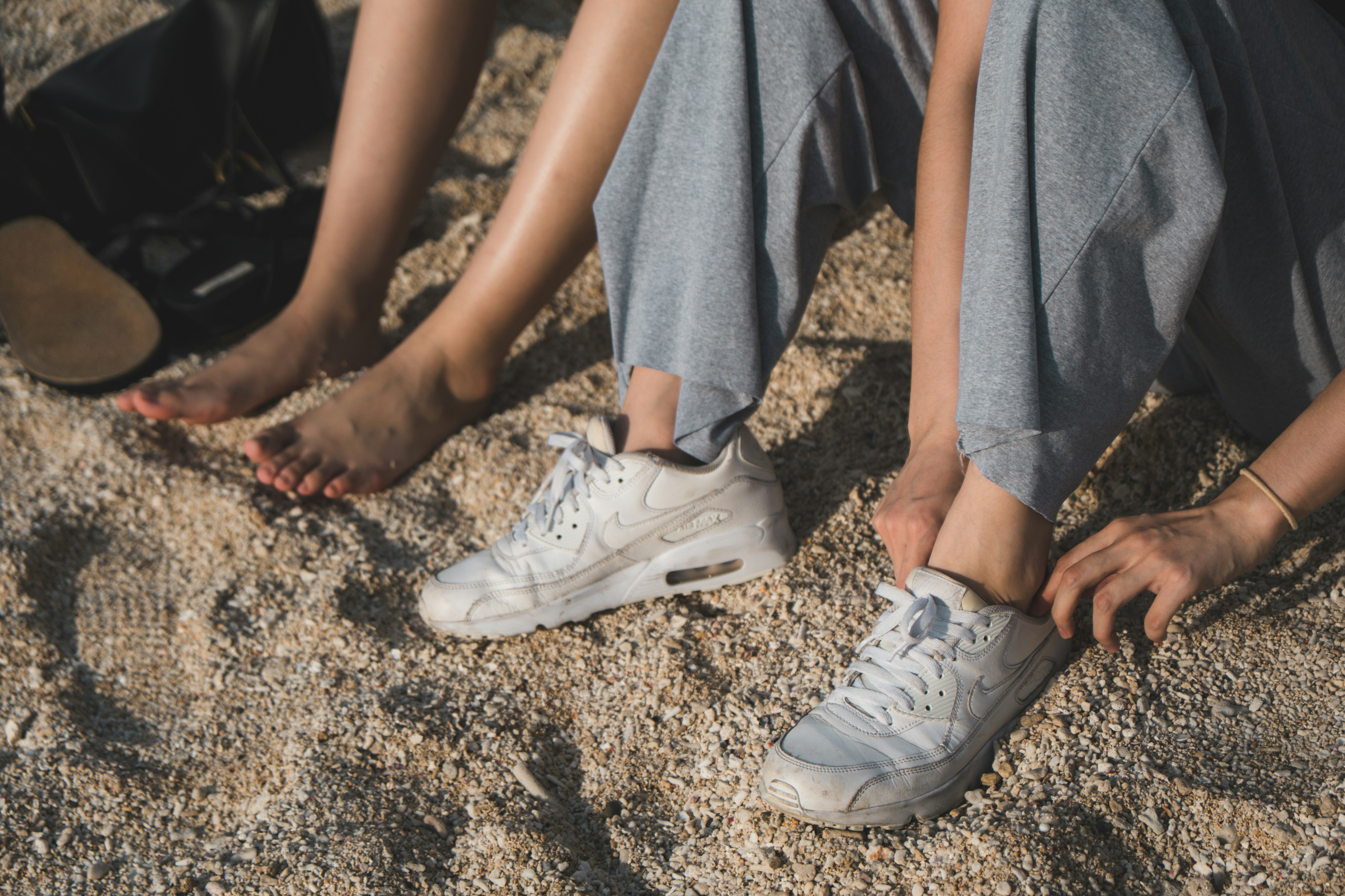 person in blue pants and white sneakers