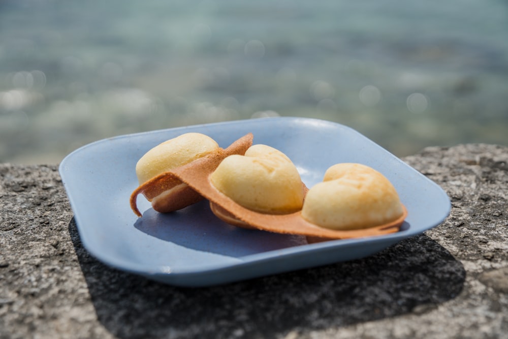 three brown cookies on white ceramic plate