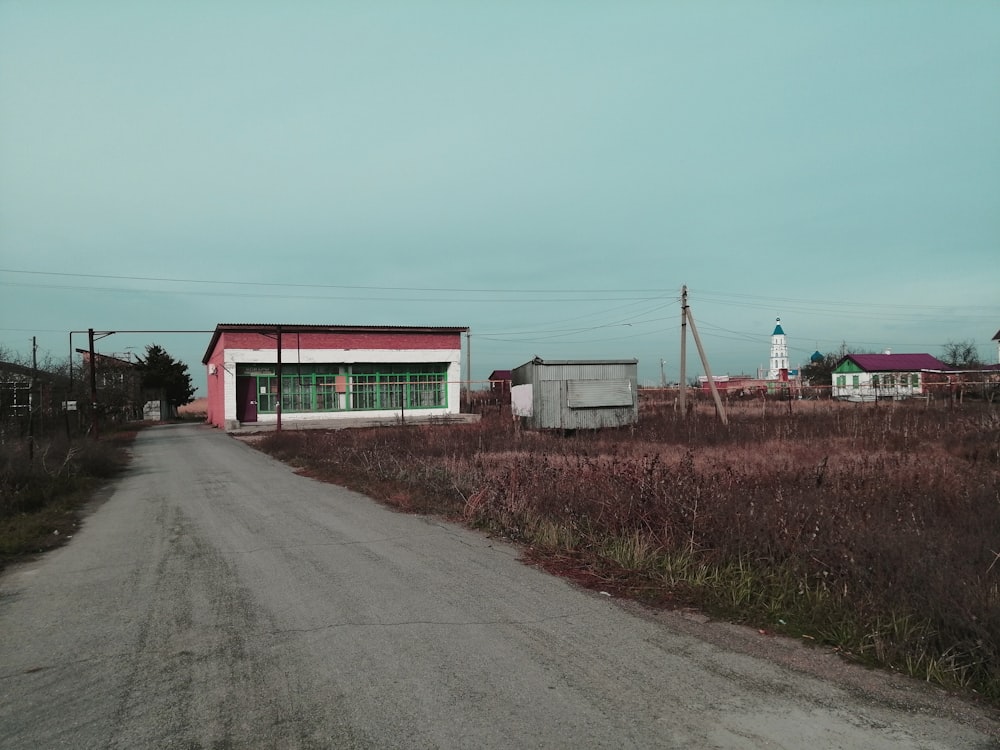 red and white house beside road during daytime