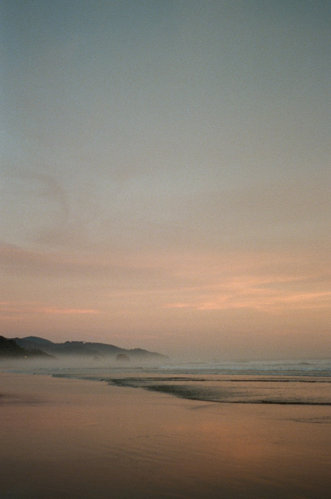 sea waves crashing on shore during sunset