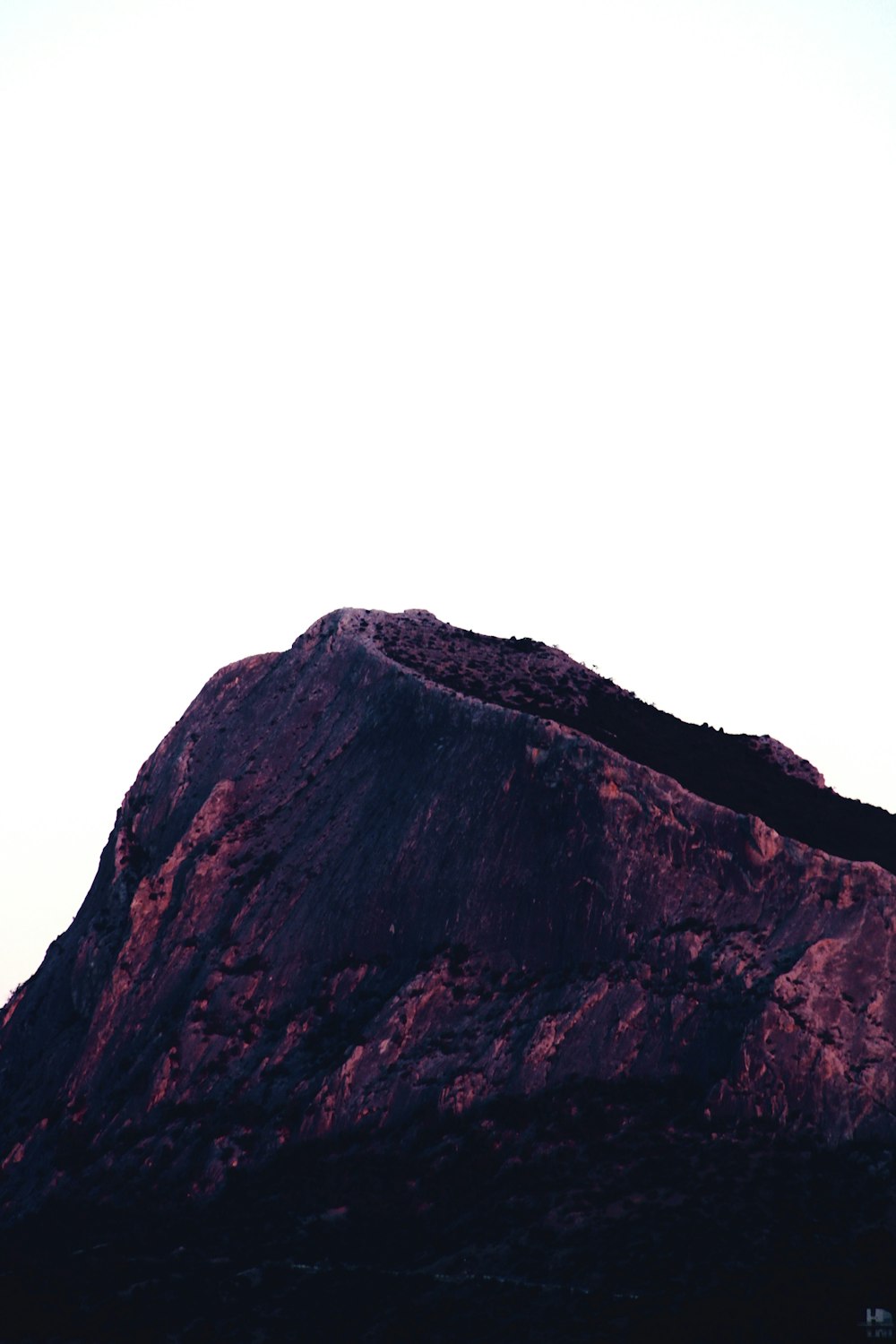 brown rocky mountain under white sky during daytime