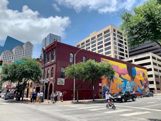 people riding motorcycle near brown concrete building during daytime