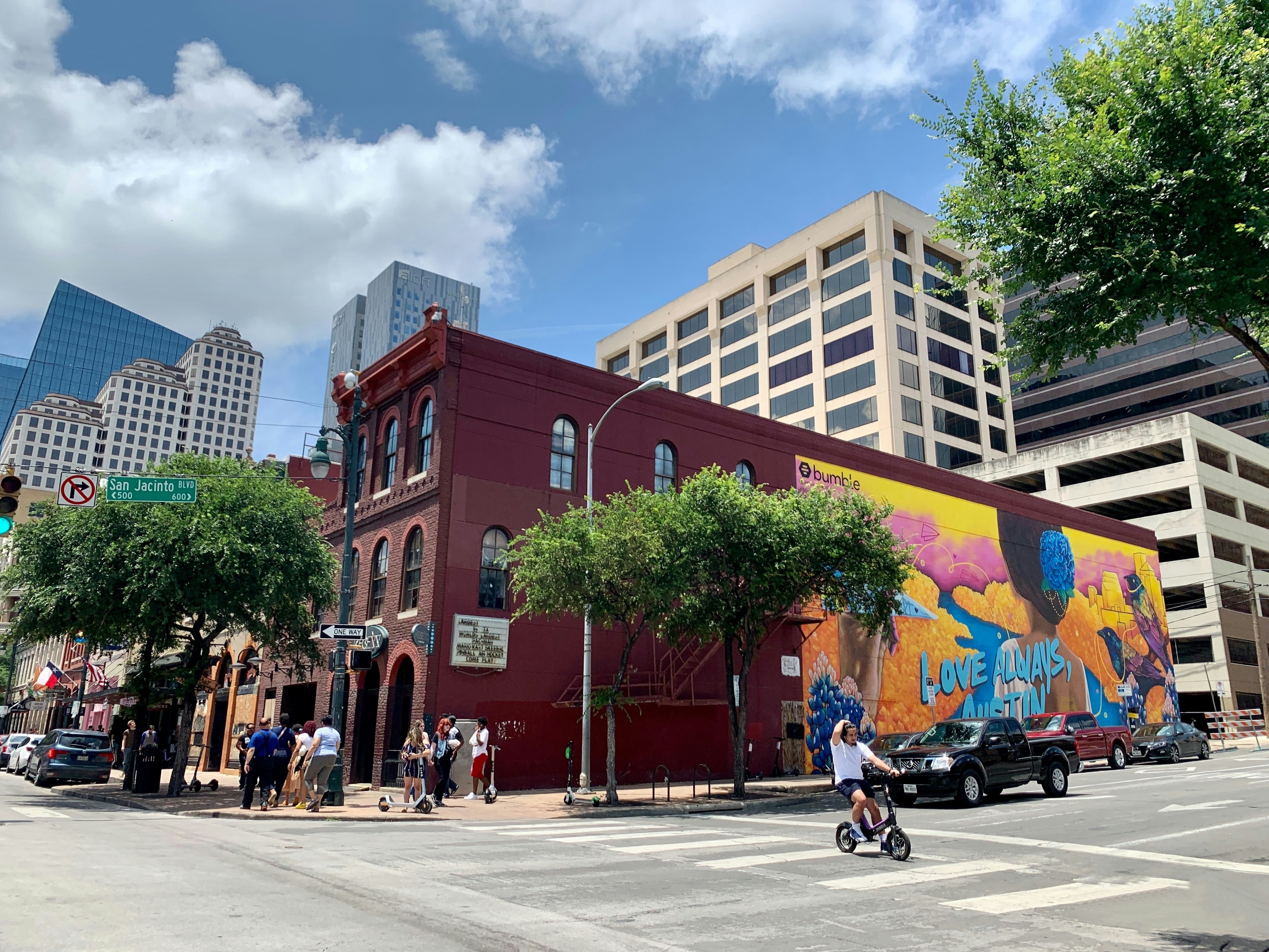 Typical street life with pedestrians and bars line up in 6th Street East Austin.