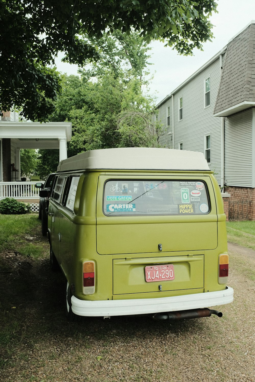 blue van parked beside green tree during daytime