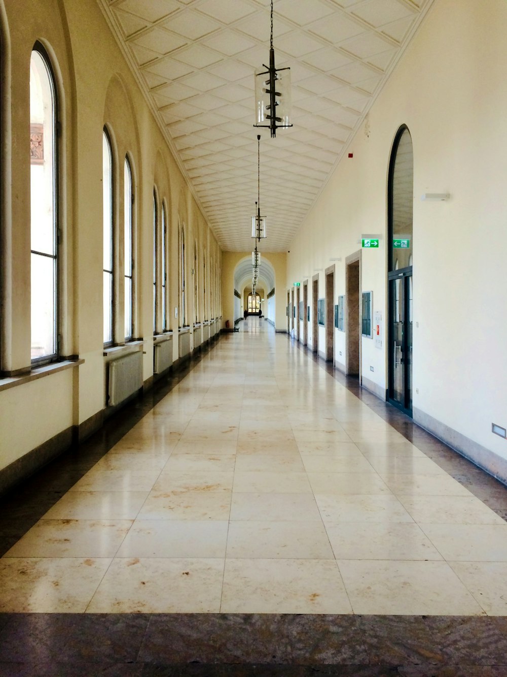 white and blue hallway with white floor tiles