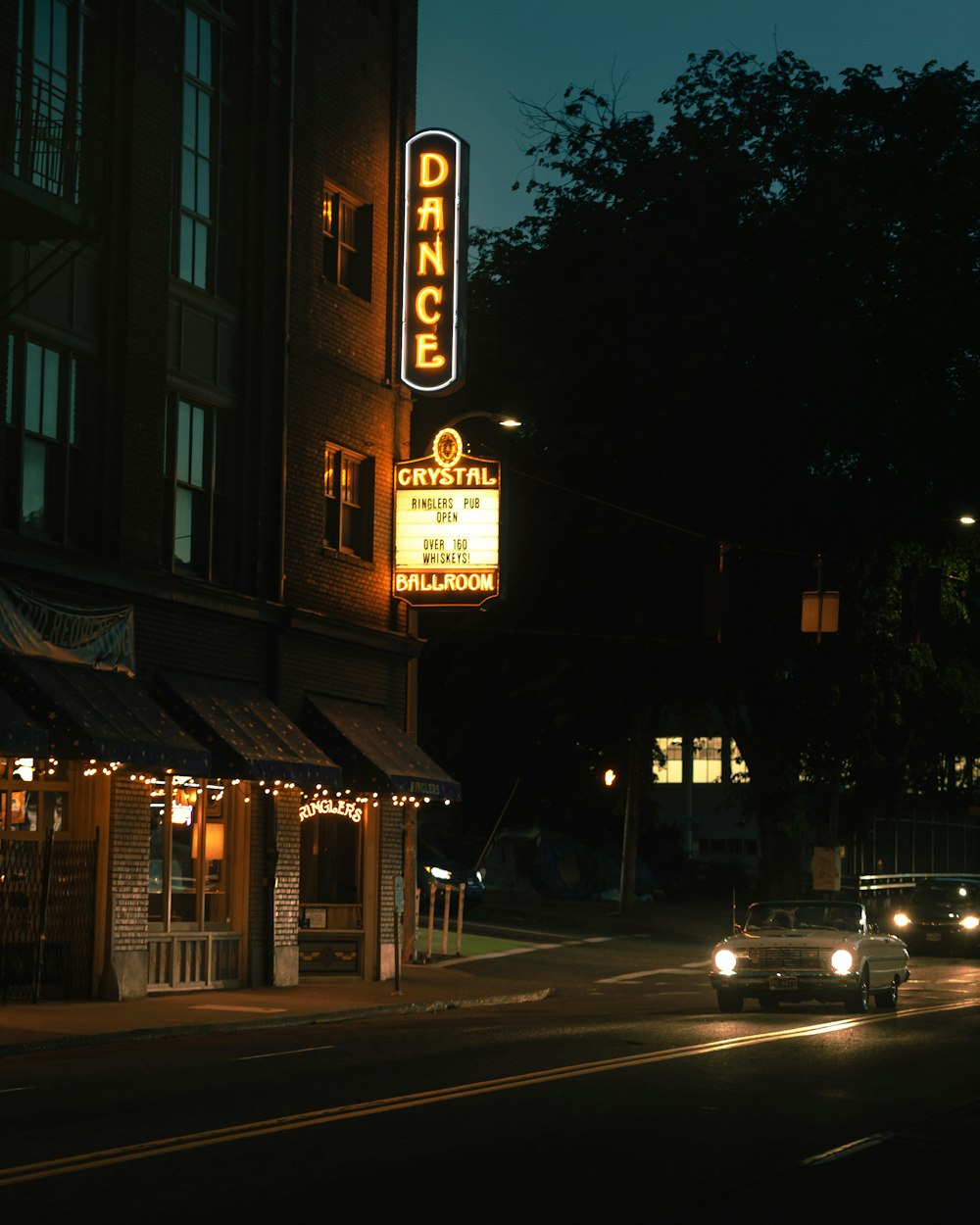 cars parked beside building during night time