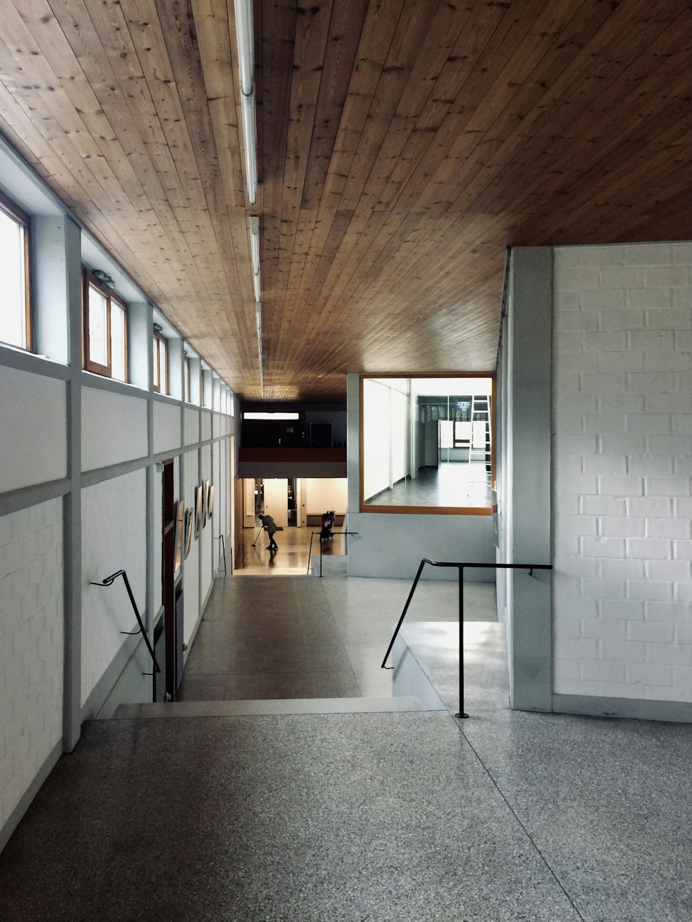 white and brown hallway with glass windows