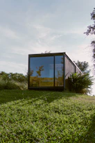 brown wooden framed glass window on green grass field during daytime