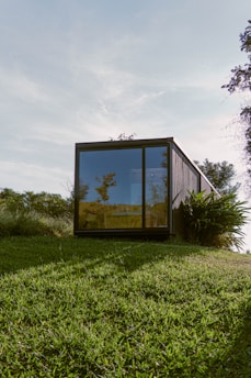 brown wooden framed glass window on green grass field during daytime