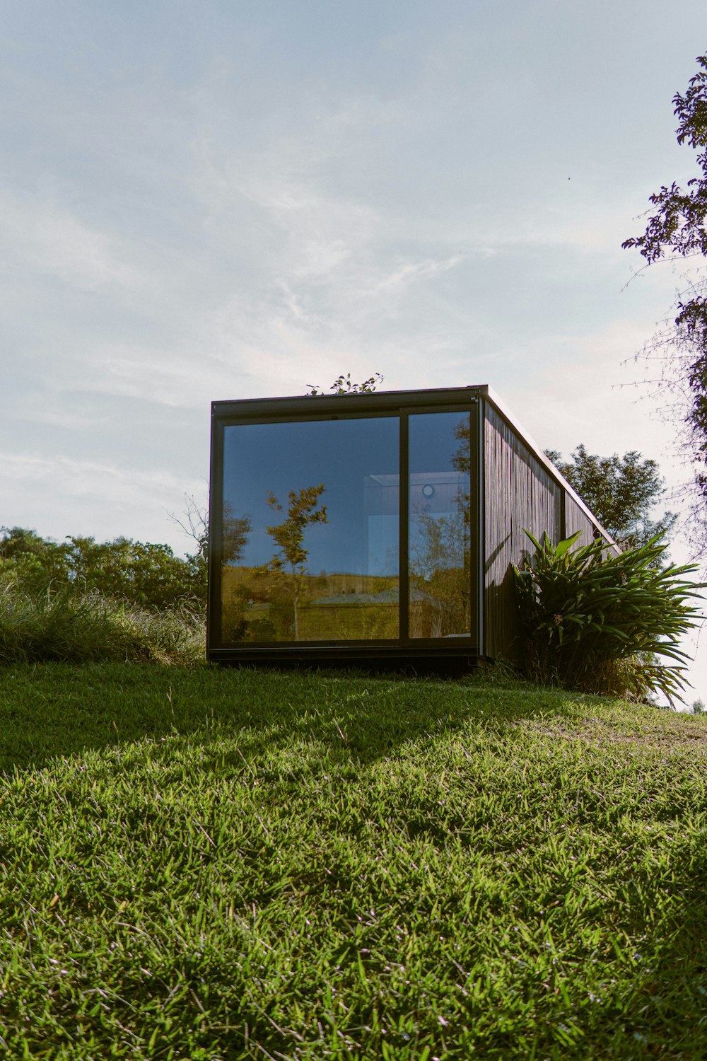 brown wooden framed glass window on green grass field during daytime