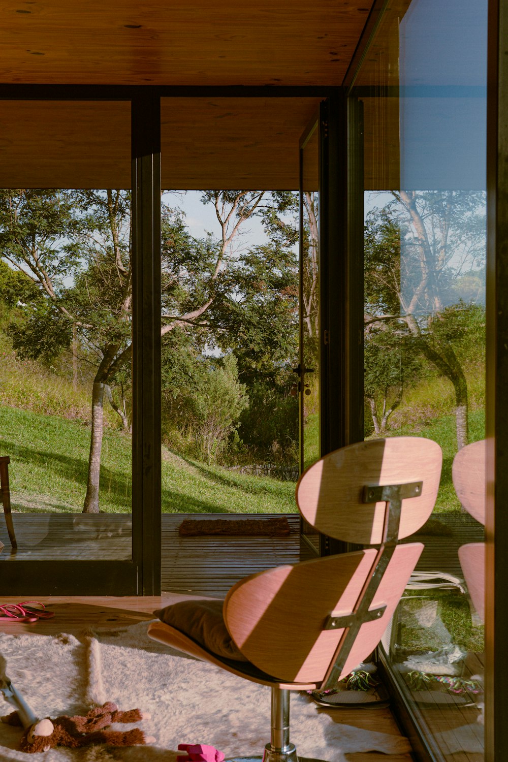 brown wooden chair near glass window