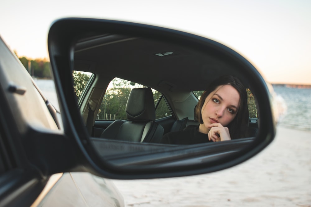 girl in car taking selfie