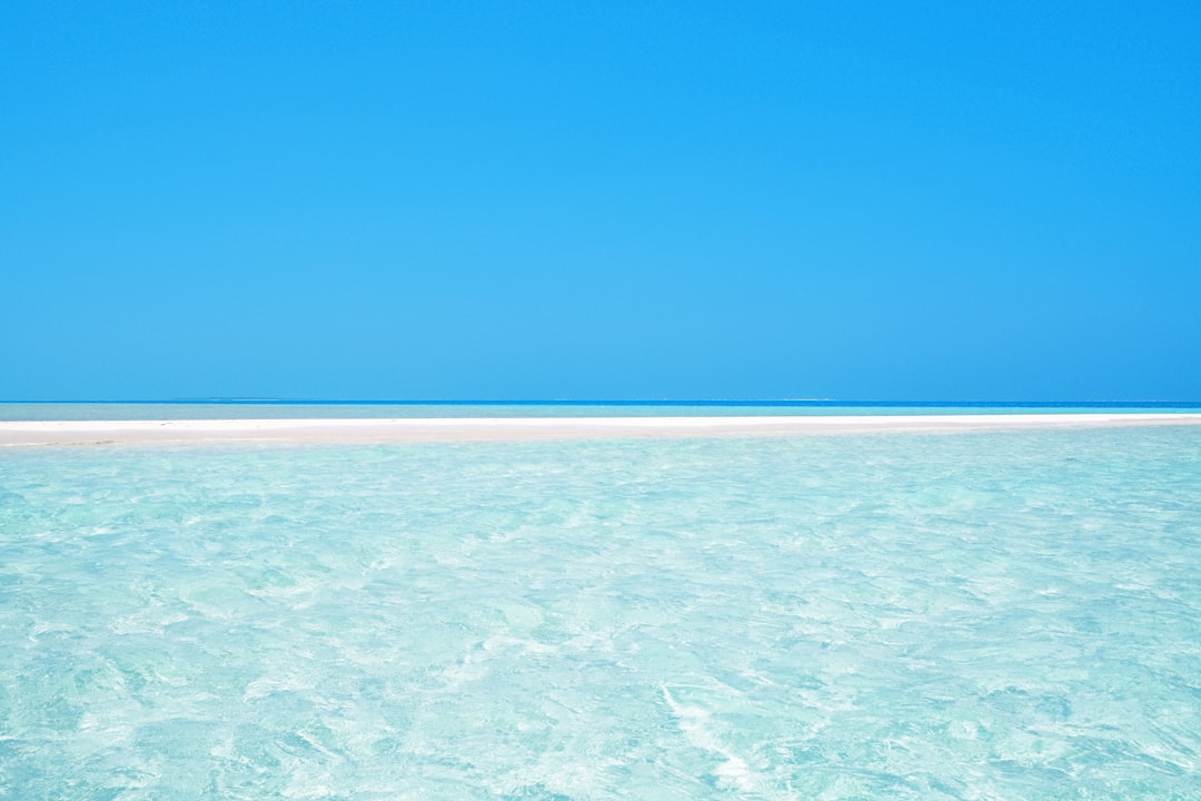 blue ocean water under blue sky during daytime