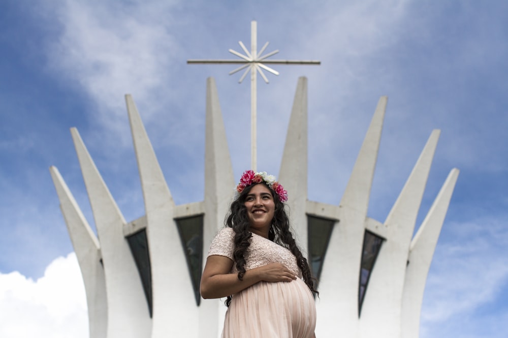 woman in white dress wearing pink floral headdress