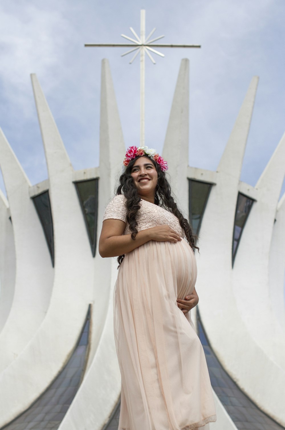 woman in beige dress wearing red and white floral head band