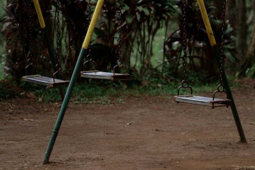 yellow and green swing on brown soil