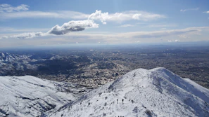 A panoramic mountain view with hikers enjoying the crisp air and clear skies
