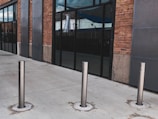 A row of bollards installed along a commercial property.