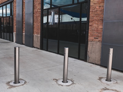 A row of bollards installed along a commercial property.