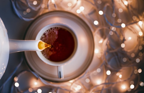 white ceramic mug on clear glass table
