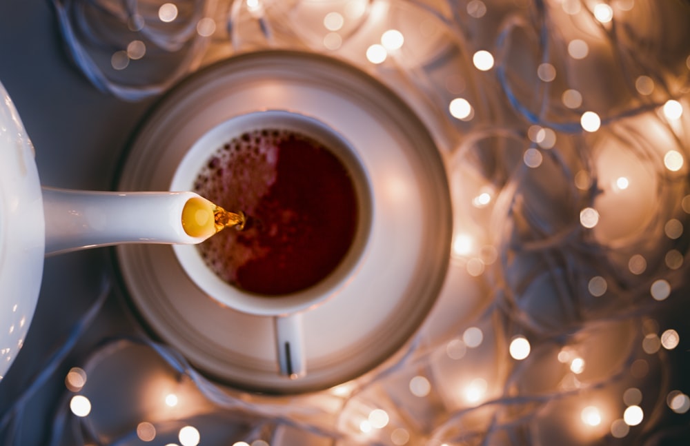 white ceramic mug on clear glass table