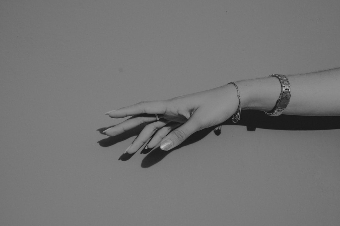 grayscale photo of persons hand