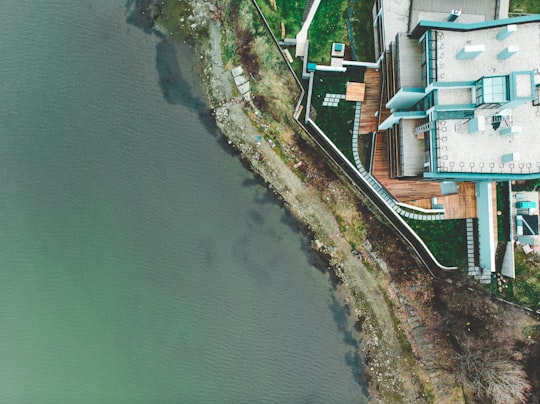 aerial view of houses near body of water during daytime in Pancharevo Bulgaria