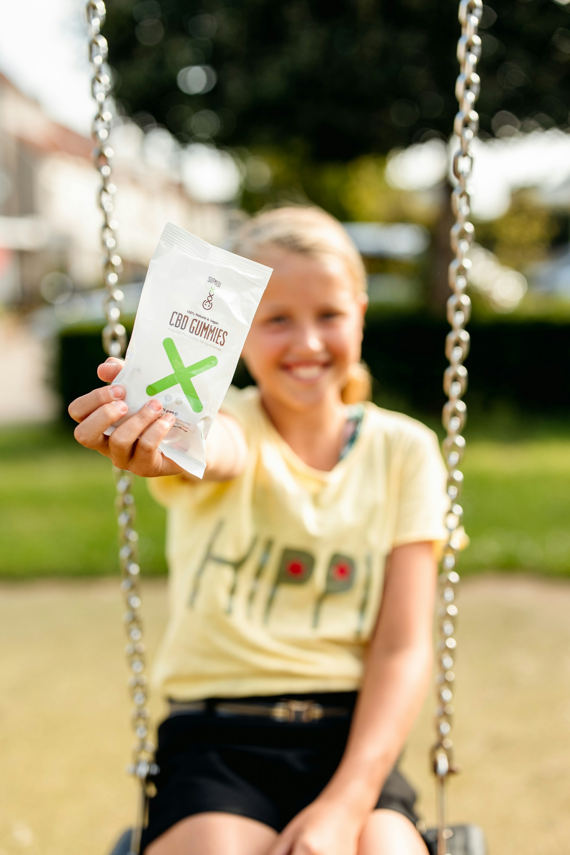 Mädchen im weißen Rundhals-T-Shirt sitzt tagsüber auf Schaukel