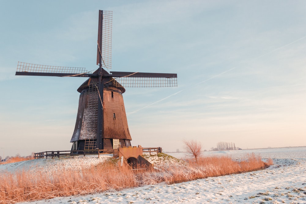 brown windmill on brown grass field during daytime