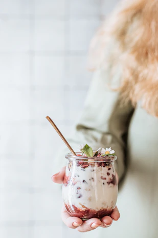 Hands crafting yogurt in a rustic, artisanal process.