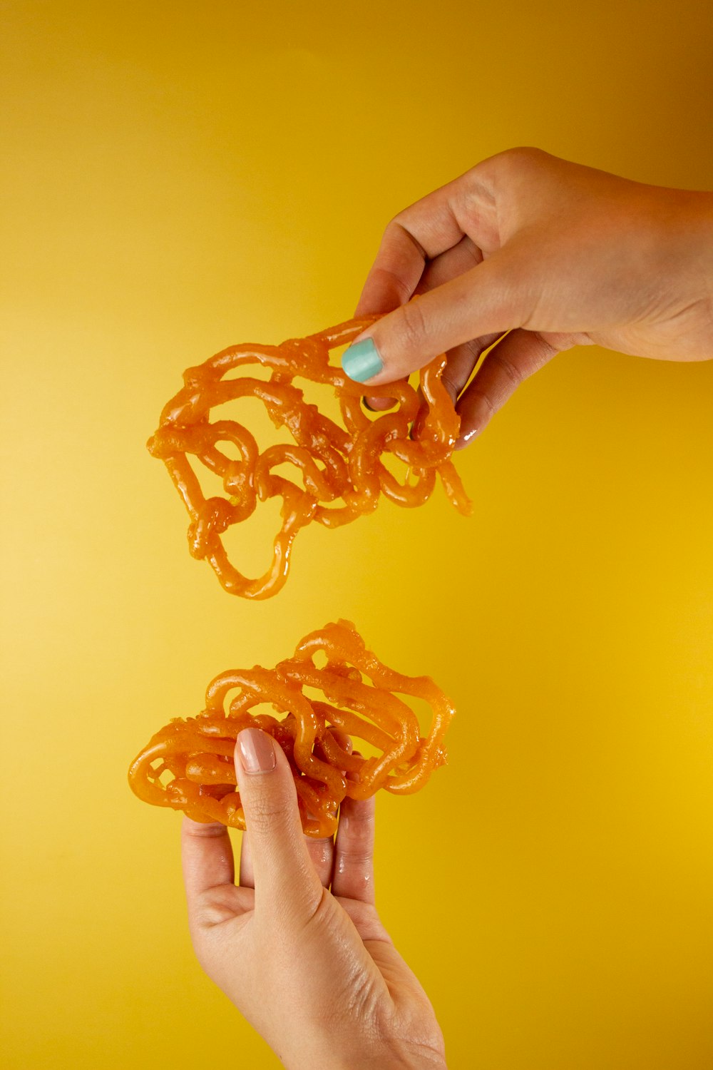 person holding orange plastic toy