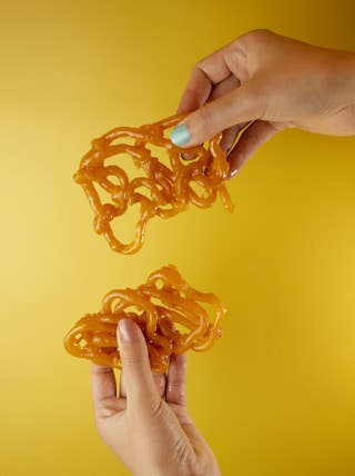 person holding orange plastic toy