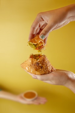 person holding brown bread with cheese