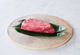 raw meat on white and green floral ceramic plate