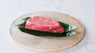 raw meat on white and green floral ceramic plate