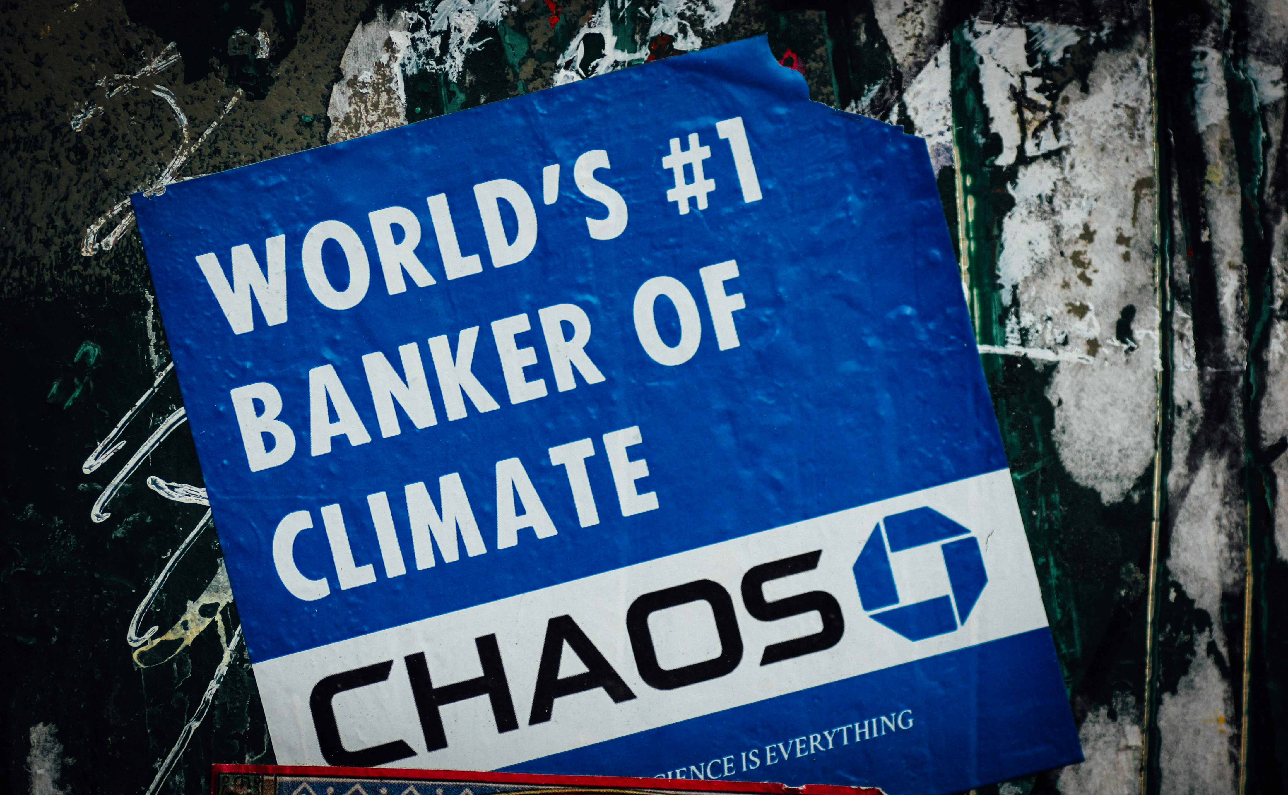 a blue sign that says world's 1 banker of climate chaos