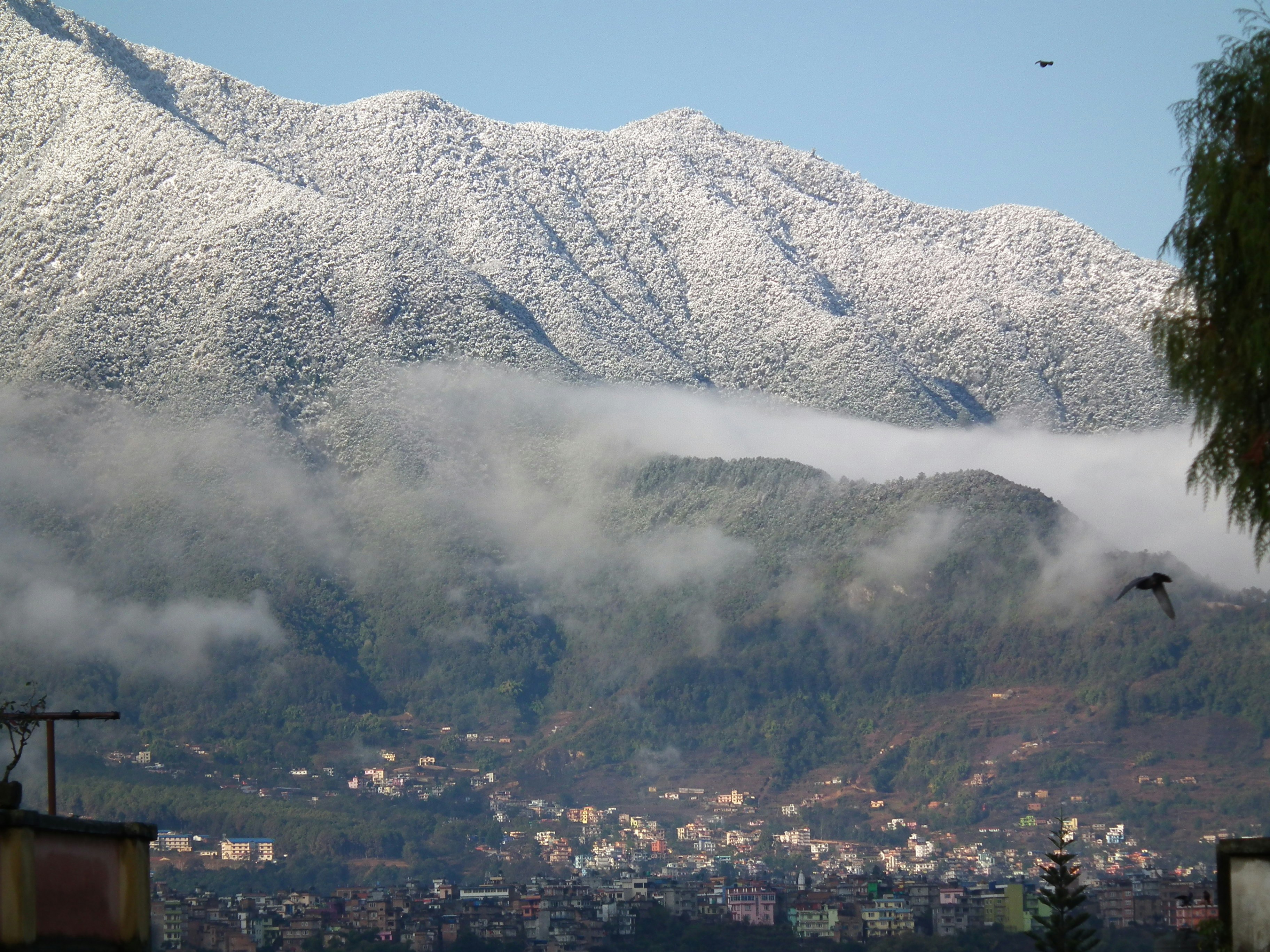 white and black mountain under white clouds during daytime