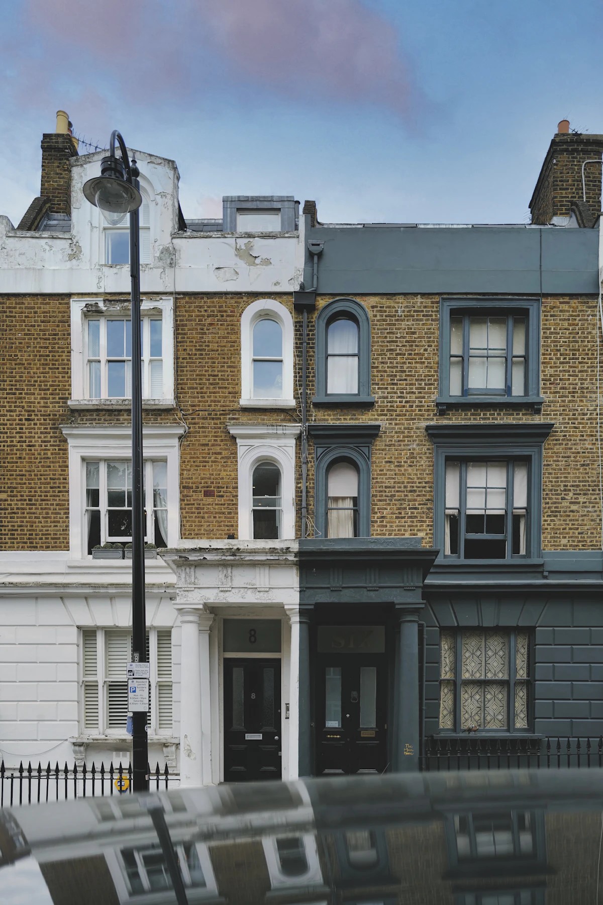 A white and grey concrete apartment building