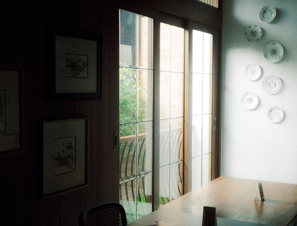 brown wooden table near brown wooden framed glass door