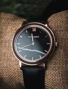 black and silver round analog watch